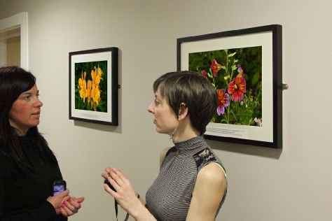 Justyna Dakowicz and Dimitra Kountiou discussing the photographic exhibition.