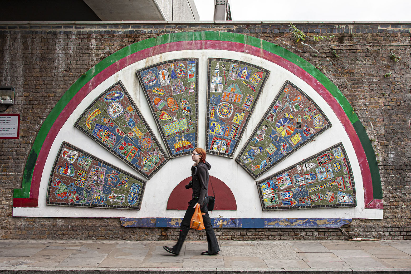 Street Art in East London with Kate walking past.