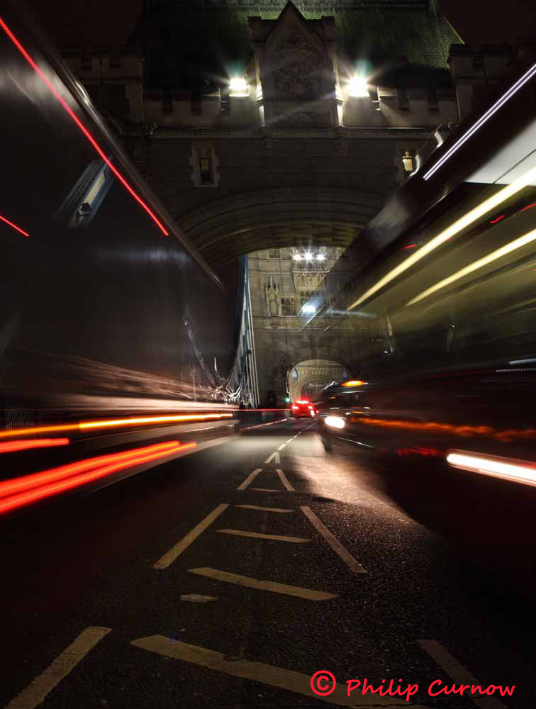 Tower Bridge at night, with passing traffic